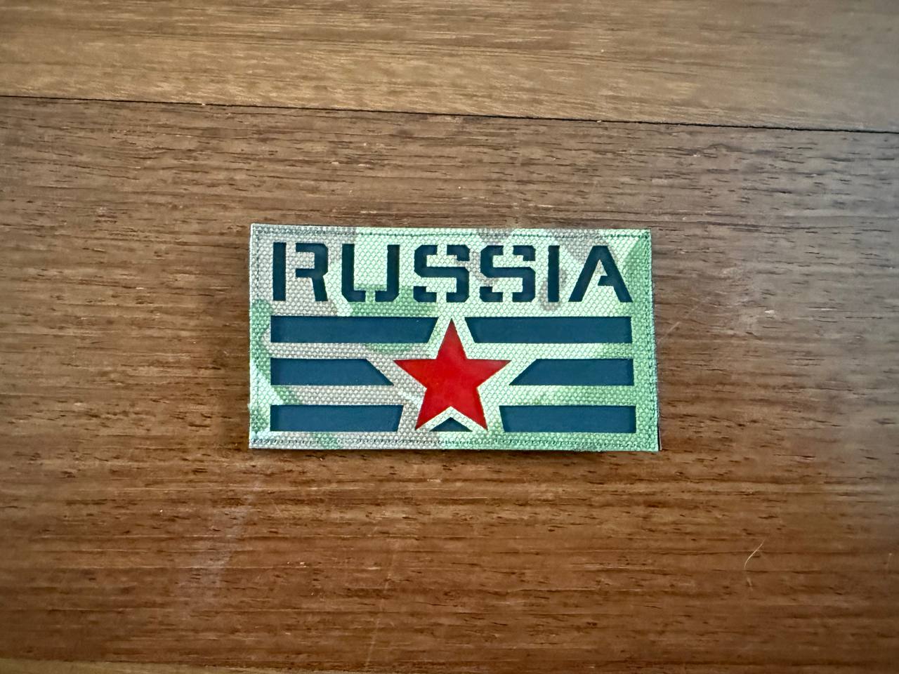 The Russian Soviet Red Star Design Patch - MultiCam Badge by Tanki Store features RUSSIA in bold, a central red star, and green/gray stripes—ideal for bulk orders or to complete your patch collection.
