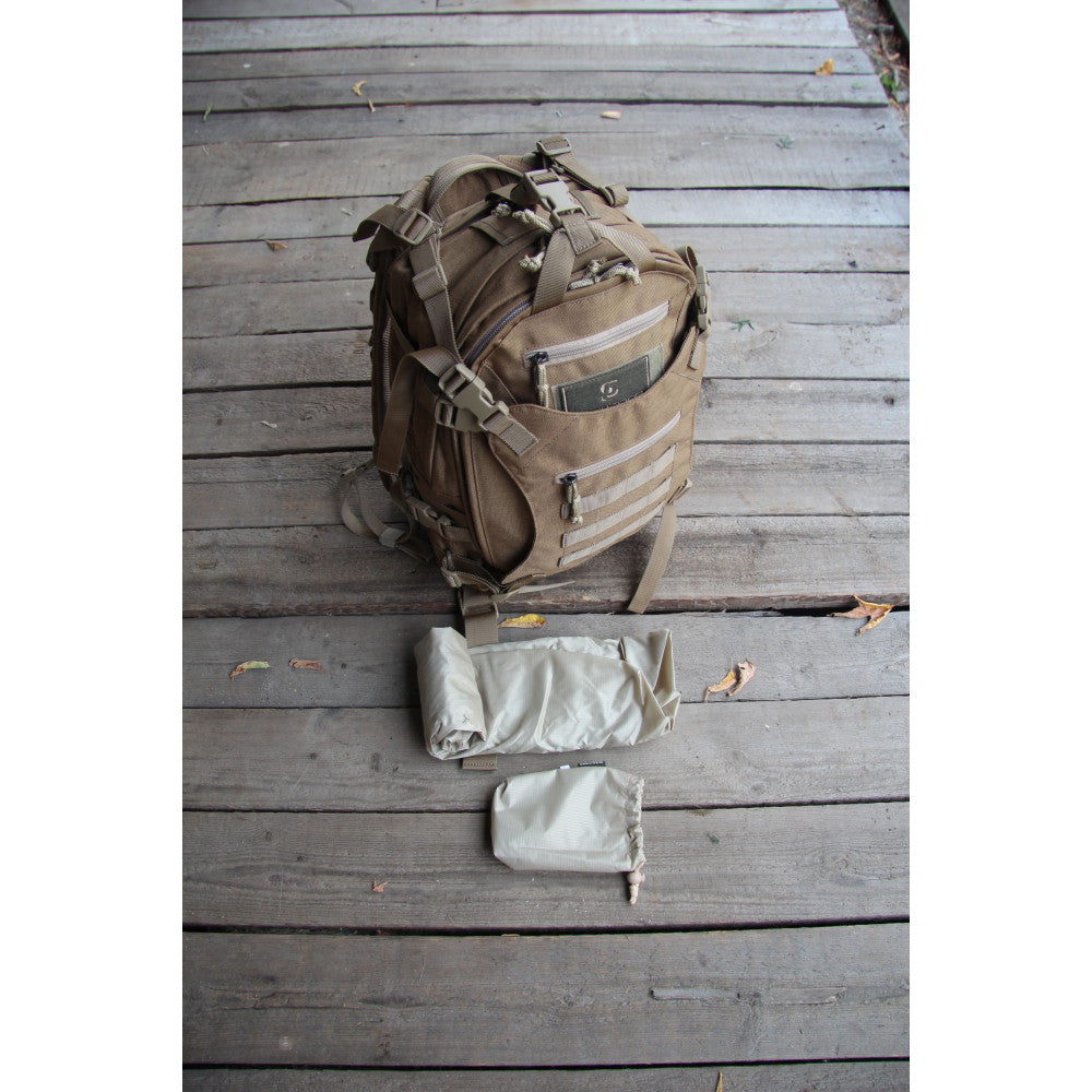 Tactical backpack with accessories on a wooden surface