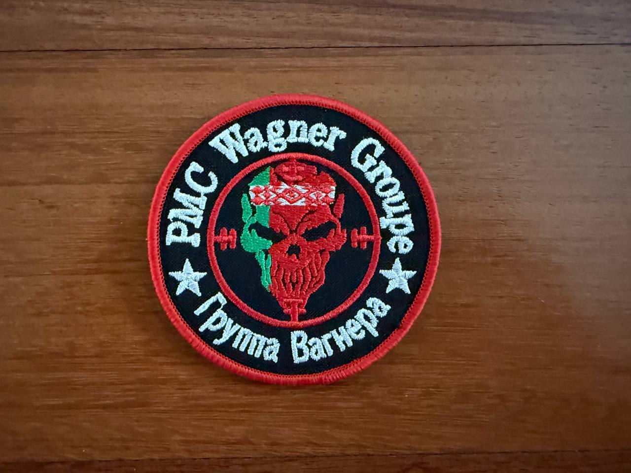 The PMC Wagner Badge - Russian Army Military Patch by Tanki Store features a red skull, green and red globe, and PMC Wagner Group/Группа Вагнера text with white stars on red and black—a perfect collector’s patch for bulk buyers at the best price.