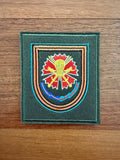 Embroidered patch with a colorful design on a wooden surface