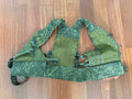 Green camouflage tactical vest on a wooden floor