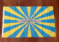 Russian Air Forces Flag - 150x90cm featuring blue and yellow rays with a winged propeller emblem in the center, representing Russian surplus aviation symbolism.