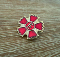 Russian GRU Service Pin featuring a red and gold star-shaped design with Cyrillic letters, displayed on a textured wooden surface, vintage Russian surplus style.
