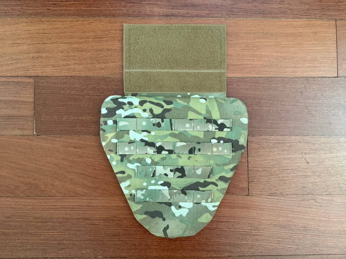 Russian Wartech - TV-130 "Conus" Groin Protector Pad – Multicam displayed on a wooden surface, featuring a camouflage pattern and adjustable Velcro strap.