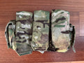 Eighty-Four - Triple Rifle Mag Placard from Kommandostore – Multicam - USED laid flat on wooden surface, showing three camouflaged fabric magazine pouches with flap covers.