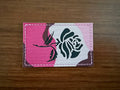 Close-up of a Russian Tactical Rose Pink Camo - Military Patch featuring a stylized rose design on a fabric patch with pink, white, and brown camouflage background.