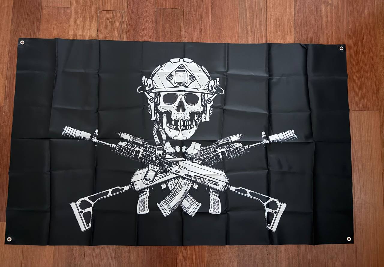 Russian Tactical "Jolly Roger" Flag - 150x90cm featuring a black background with a skull wearing a military helmet and crossed assault rifles in front, symbolizing tactical and Russian surplus themes.