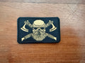 Russian Viking Gold Toned - Military Patch featuring a gold-toned Viking skull with crossed axes on a black background, highlighting detailed embroidery and bold design.