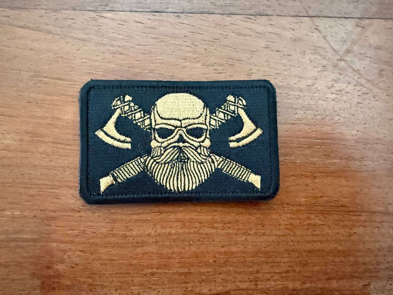 Russian Viking Gold Toned - Military Patch featuring a gold-toned Viking skull with crossed axes on a black background, highlighting detailed embroidery and bold design.
