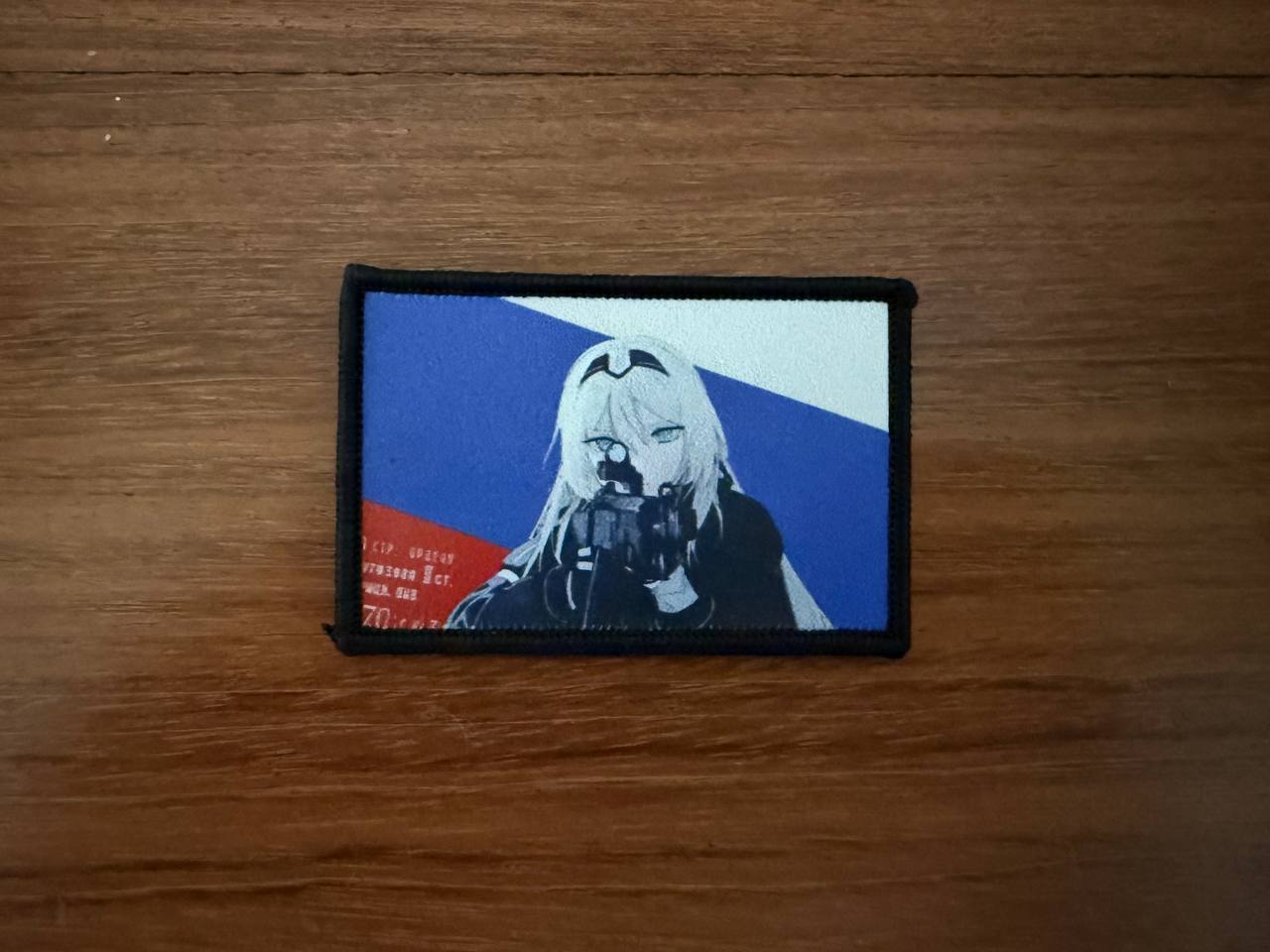 Russian Anime Girl Operator - Military Patch featuring an anime-style female soldier aiming a rifle against a blue and red background, styled with tactical military theme.