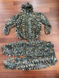 Russian Praktika Special Leaf Suit - Autumn Camo (FSB Contract) - Size 54-56/5-6 displayed flat on wooden floor, featuring a textured camouflage jacket and pants with leaf-like fabric for concealment.