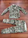 Russian Slavyanka FSB Contract Set – Multicam - Size 54/5 laid out on a wooden floor, featuring a camouflaged jacket and matching tactical pants designed for military use.