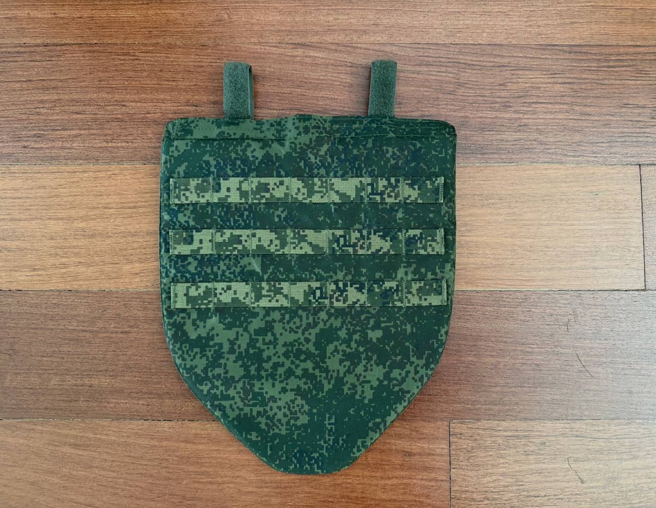 Russian SSO - Tactical Groin Pad – EMR (Digital Flora) in a digital flora camouflage pattern, laid flat on a wooden surface, designed for protective military use.