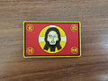 Russian Orthodox "IC XC NIKA" Red PVC - Military Patch featuring a stylized icon face on a red background with yellow and black accents, representing Russian surplus military style.