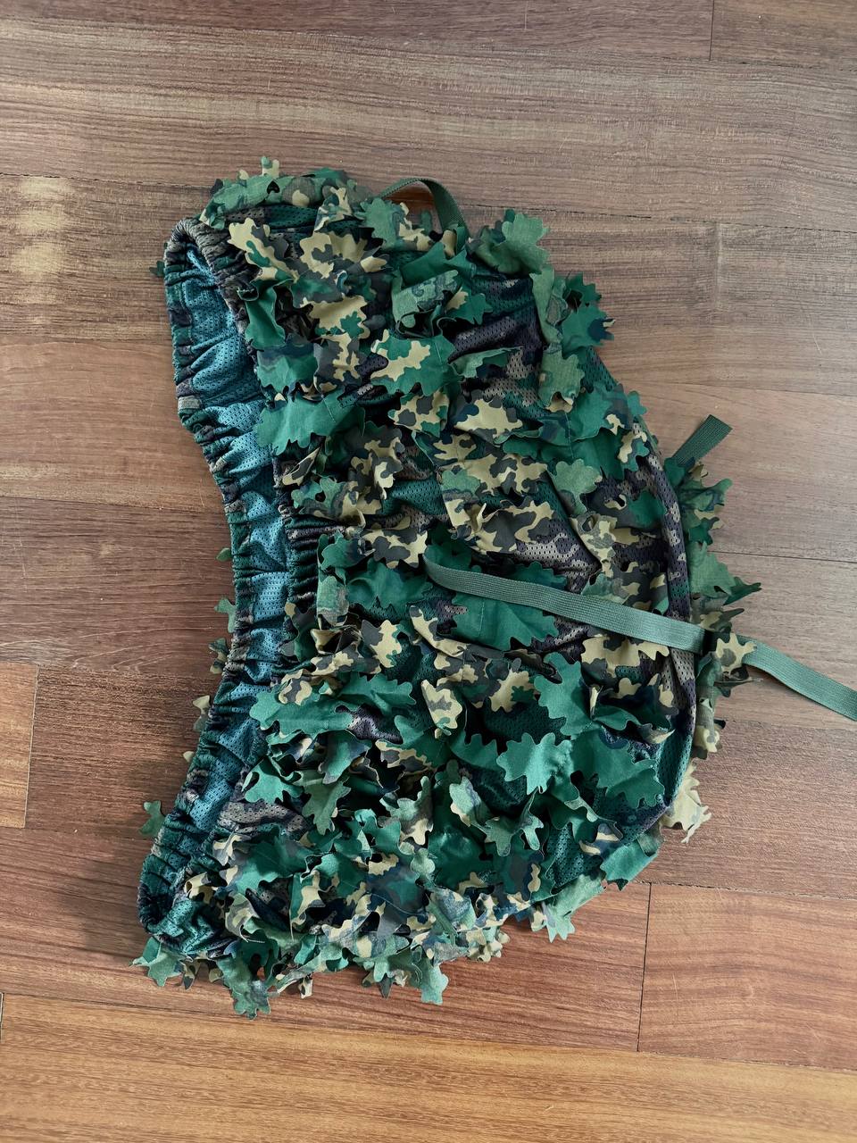 Russian SS-Leto Backpack Cover (40–60L) in green and brown camouflage, designed for outdoor use and blending into natural woodland environments.