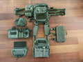 Russian MBC - "Fantom" Vest – OD Color (2018 Production) laid out with multiple green tactical pouches and modular attachments on a wooden floor, showing its full gear configuration.