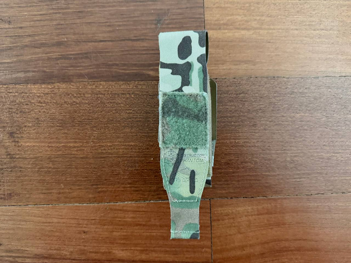 Russian Ars Arma - "Super 86" Laser-Cut Tourniquet Pouch – Multicam (Used) displayed on wooden surface, featuring a compact tactical design in camouflage pattern.