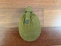 Russian Soviet Army Aluminum Water Flask (Canteen) with Canvas Cover in olive green, displayed on a wooden surface, showcasing vintage Russian surplus military gear.