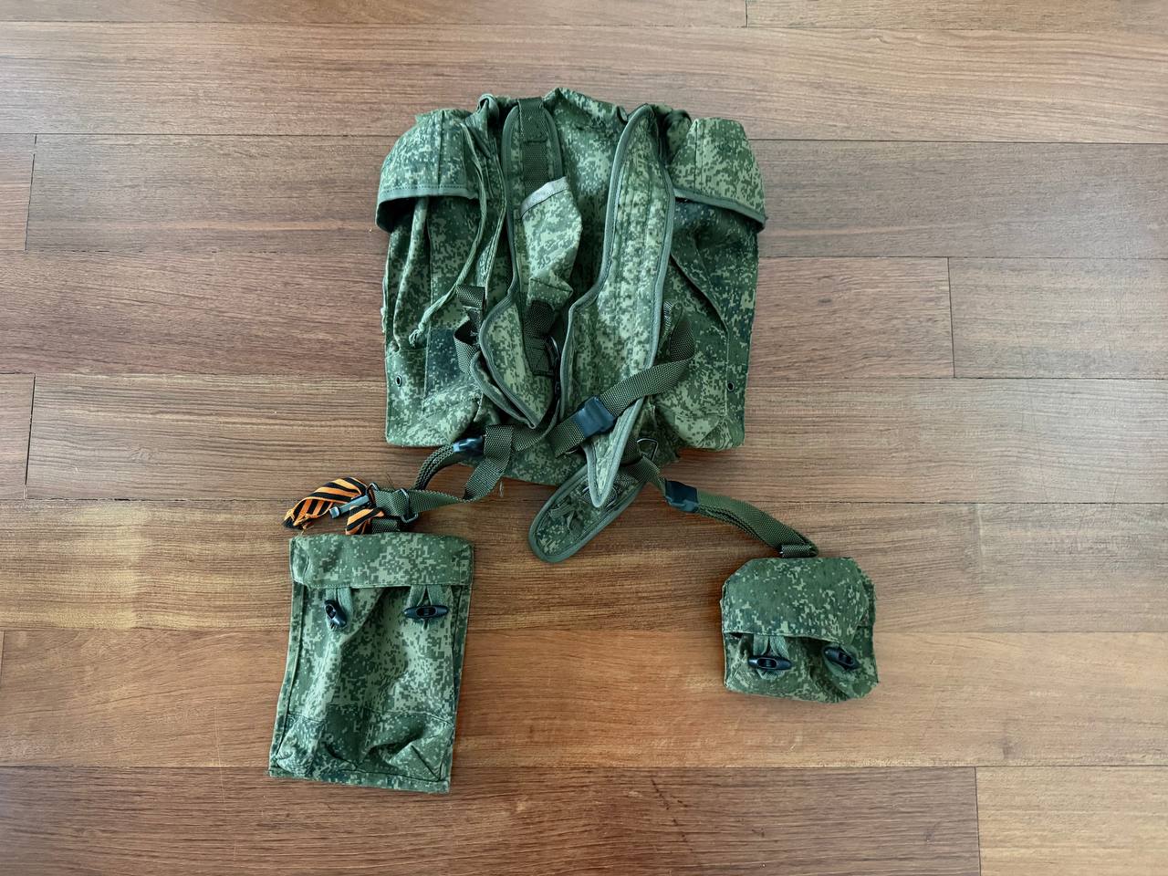 Russian RD-54 Backpack - VDV Airborne Paratrooper Bag - EMR in digital camouflage, laid flat showing padded shoulder straps and attached utility pouches on wooden floor.