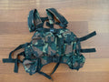 Russian "Vydra" Style Tactical Load-Bearing Vest in camouflage pattern designed for carrying equipment and gear, laid flat on wooden floor surface.