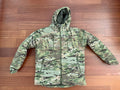Russian Innovation Cold Weather Jacket (Layer 7) – Multicam - Size 54/5 laid flat on a wooden floor, featuring camouflage pattern and a hood designed for cold weather conditions.