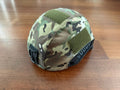 Russian LShZ 1+ Highcut Opscore Helmet - Size 3 + Multicam Cover displayed on a wooden surface, featuring a camouflage pattern and ventilation rails.