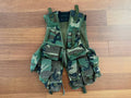 Russian Rare SRVV "Alfa" Tactical Vest - 2000-2003 FSB Spetsnaz CSN in camouflage pattern, featuring multiple pouches for gear storage, laid flat on wooden floor.