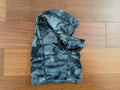 Russian Summer Tactical Balaclava - Black A-TACS AU Camo laid flat on a wooden surface, showing its camouflaged pattern and tactical design features.
