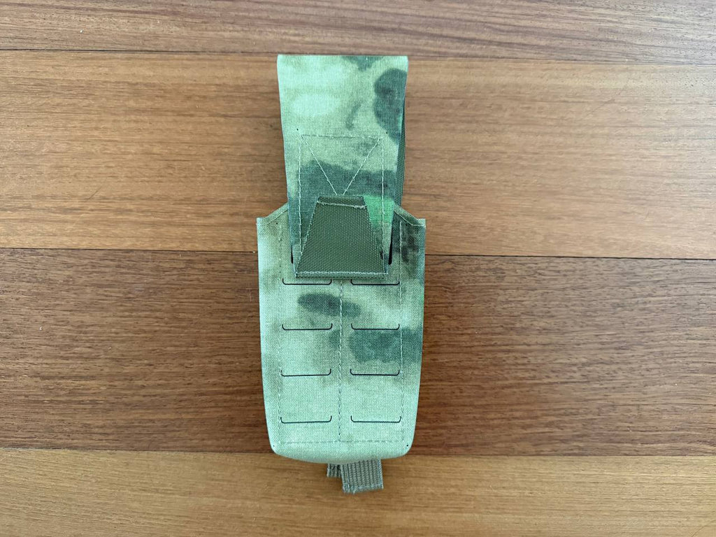 Russian Gearcraft Double AK Mag Pouch (2CELL) - A-TACS FG Camo in green camo pattern, designed for carrying two AK magazines, laid flat on a wooden surface.