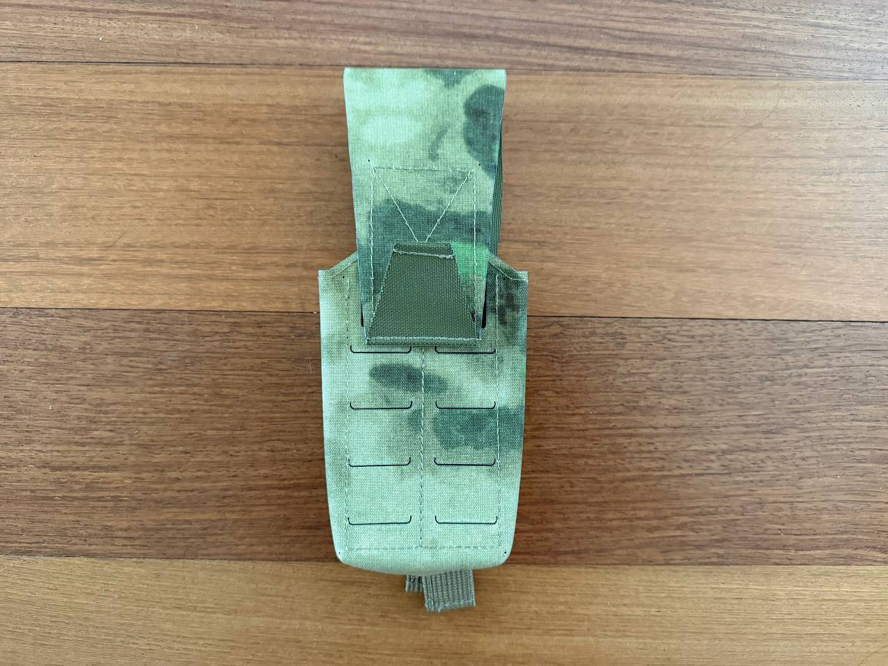 Russian Gearcraft Double AK Mag Pouch (2CELL) - A-TACS FG Camo in green camo pattern, designed for carrying two AK magazines, laid flat on a wooden surface.
