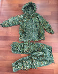Russian Sokl Leshy 4 Leaf Suit - Summer Pattern - Size 50-52/3 laid out flat on a wooden surface, featuring a green leafy camouflage design for outdoor concealment.