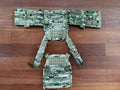 Ukrainian M-Tac Vest - Multicam displayed flat on a wooden floor, showing its camouflage pattern, adjustable straps, and modular design.