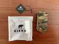 Russian Giena Tactics Open Top Single Mag Pouch - Multicam displayed on a wooden surface alongside branded packaging and tag.