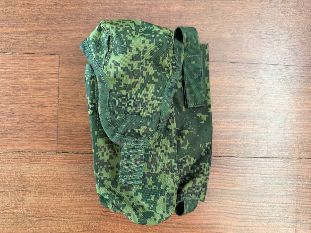 Russian Triada-Tko Left-Handed AK Dual Maga Pouch with ROP Flare Pouch - EMR in green digital camouflage pattern placed on a wooden surface, showcasing durable fabric and secure fastening.