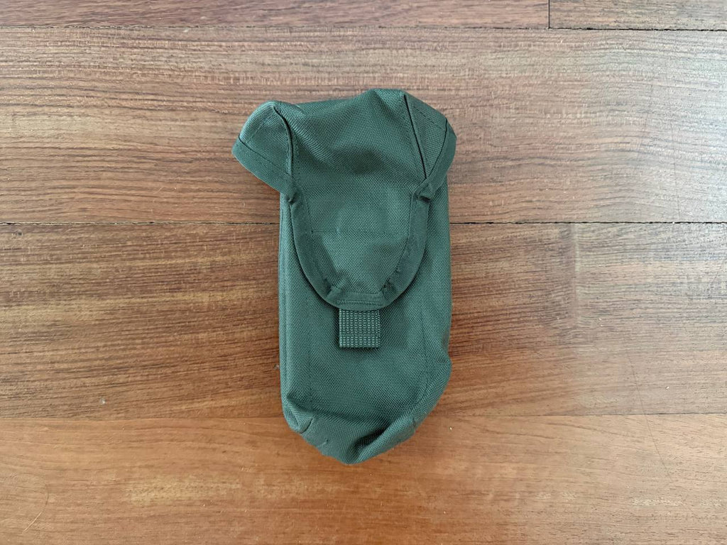 Russian Tekhinkom AK Mag Pouch (2CELL) - Olive Drab, a durable Russian surplus pouch designed to securely hold two AK magazines, displayed on a wooden surface.