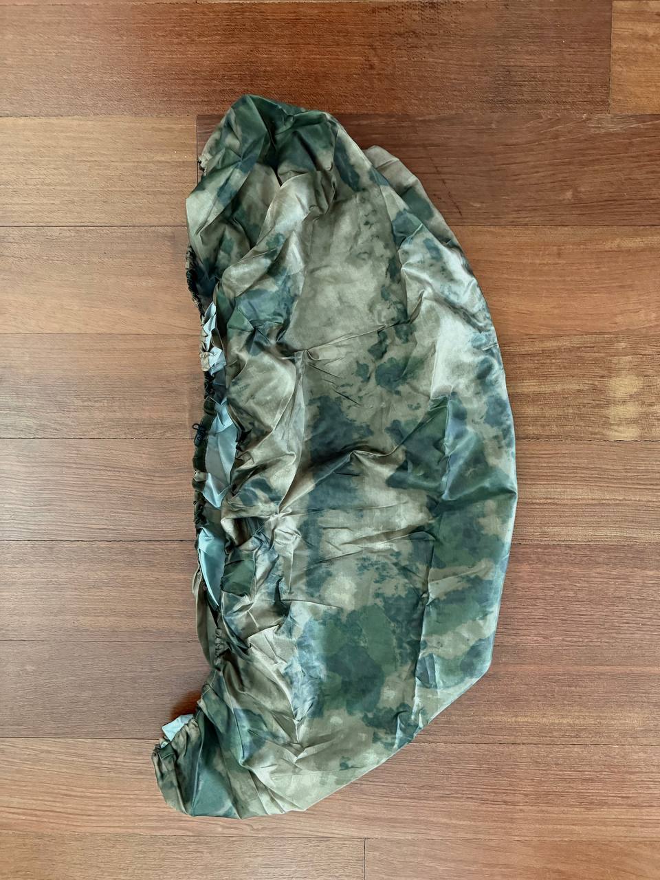 Russian PROFARMY Waterproof Backpack Cover 30-60L - A-TACS FG Moss camouflage pattern made from durable, water-resistant material, shown folded on a wooden surface.