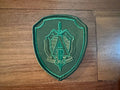 Belarus Spetsnaz Group "A" (Alpha) - Military Patch in green with embroidered sword and shield emblem on a wooden surface.