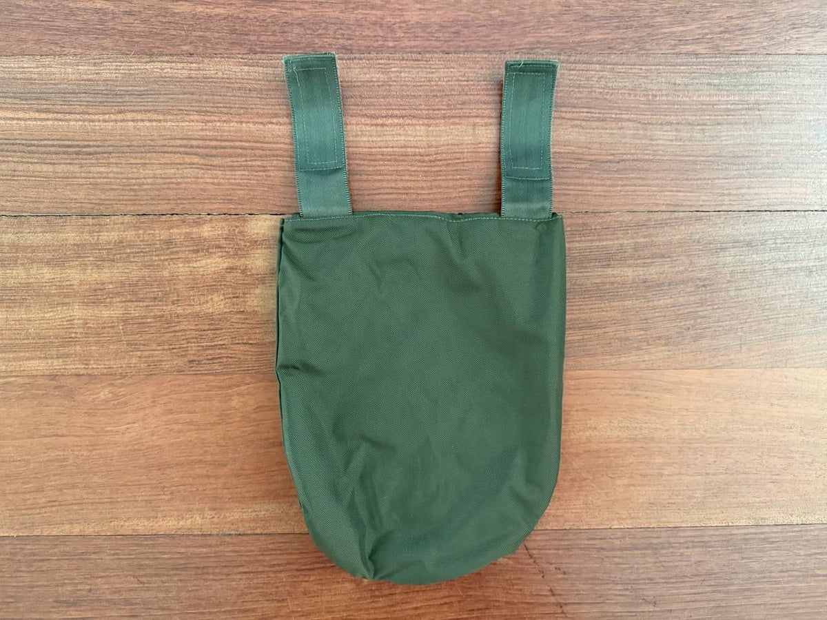 Ukrainian Korsar Groin Pad Cover - Olive Drab displayed against a wooden surface, showcasing its durable fabric and adjustable strap design.