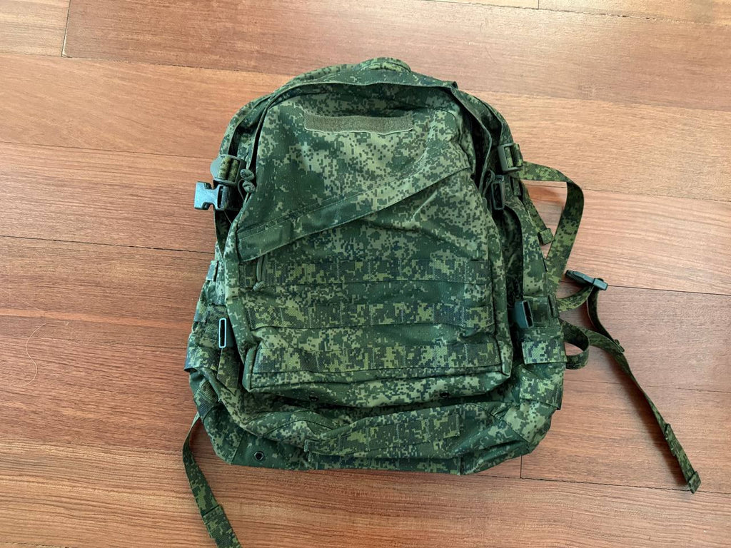 Russian Tehkinkom Big Assault Backpack - EMR Digital Flora camouflage pattern tactical military backpack laid flat on wooden floor surface.