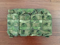 Russian Gear Craft HARD Quad AK/AR Magazine Placard - ATACS FG/Moss in camouflage pattern laid flat on a wooden surface, designed for durable magazine storage.