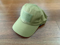 Russian Tactical Cap - Tan Color displayed on wooden surface, featuring ribbed fabric texture and square hook-and-loop patch on front panel.