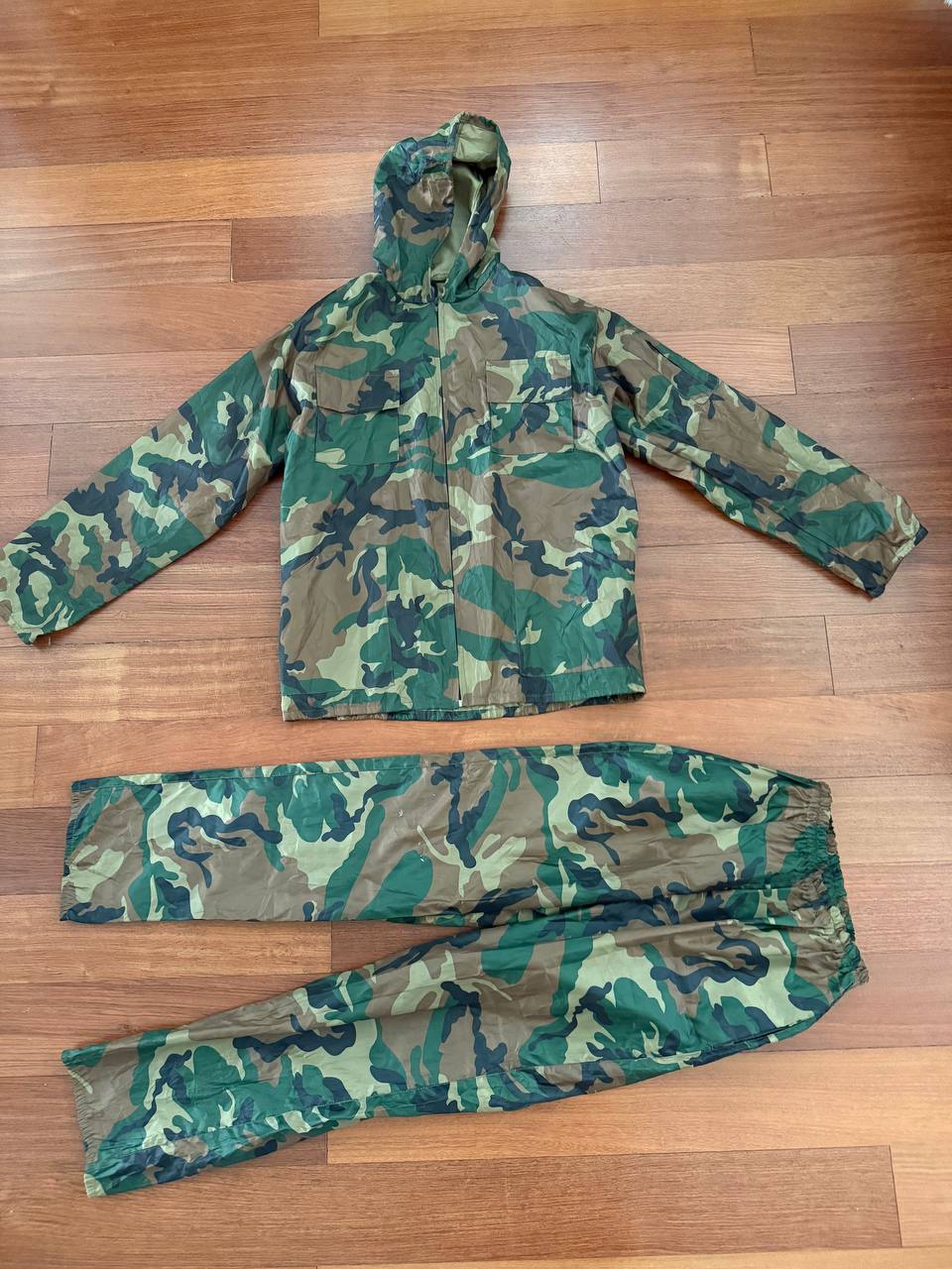 (USED) Russian Layer 6 Waterproof Windproof Suit - Size 96-100/182-188 displayed flat on wooden floor, featuring a green and brown camouflage pattern, designed as Russian surplus gear.