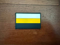 Russian Imperial Flag PVC - Military Patch featuring a rectangular design with horizontal white, yellow, and black stripes on a wooden surface.