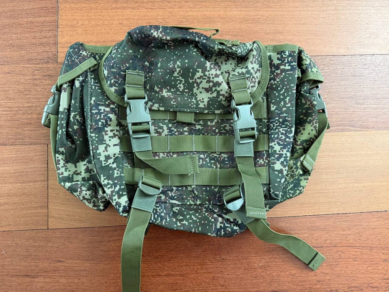Russian Triada-TKO Tactical Buttpack - EMR Camo featuring durable straps and buckles, designed for versatile use with a digital camouflage pattern on a wooden surface.