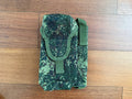 Russian Triada-TKO Left-Handed AK Dual Mag Pouch with ROP Flare - EMR Camo featuring digital camouflage fabric and secure flap closure on wooden floor background.