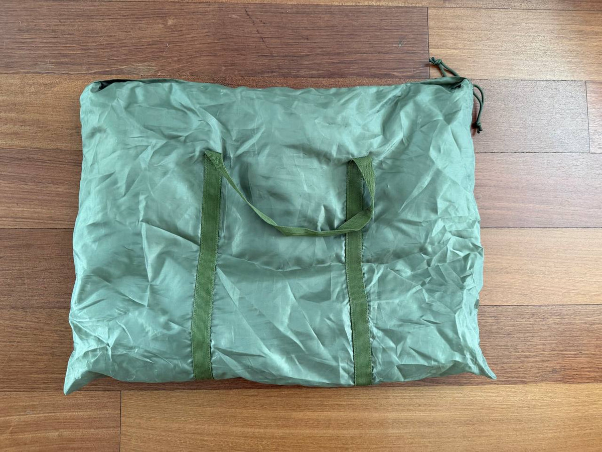 Russian Triada-TKO 6Sh117 Bag in green fabric with handles, displayed on wood floor, a durable and practical Russian surplus carrying bag.