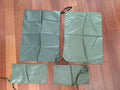 Russian Triada-TKO Waterproof Bags From 6sh117 Vest laid out on a wooden floor, showing multiple sizes of green water-resistant fabric bags designed for durable storage.