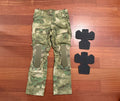 Russian Voin Tactical Combat Pants - A-TACS FG / Moss Camo - Size S-1 displayed flat on wooden floor with removable knee pads placed beside them, showcasing their durable design and camouflage pattern.