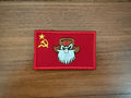 Red fabric patch featuring a cartoonish bearded man wearing a brown hat with a red star, alongside a yellow hammer and sickle symbol, Russian Soviet USSR Red Flag - Military Patch.