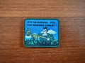 The Tanki Store’s Russian Meme Its Not Painful, Its Like Getting Hit by a Truck Patch features a cartoon man with a mallet and Russian text on a blue sky background—buy in bulk for the best price!.